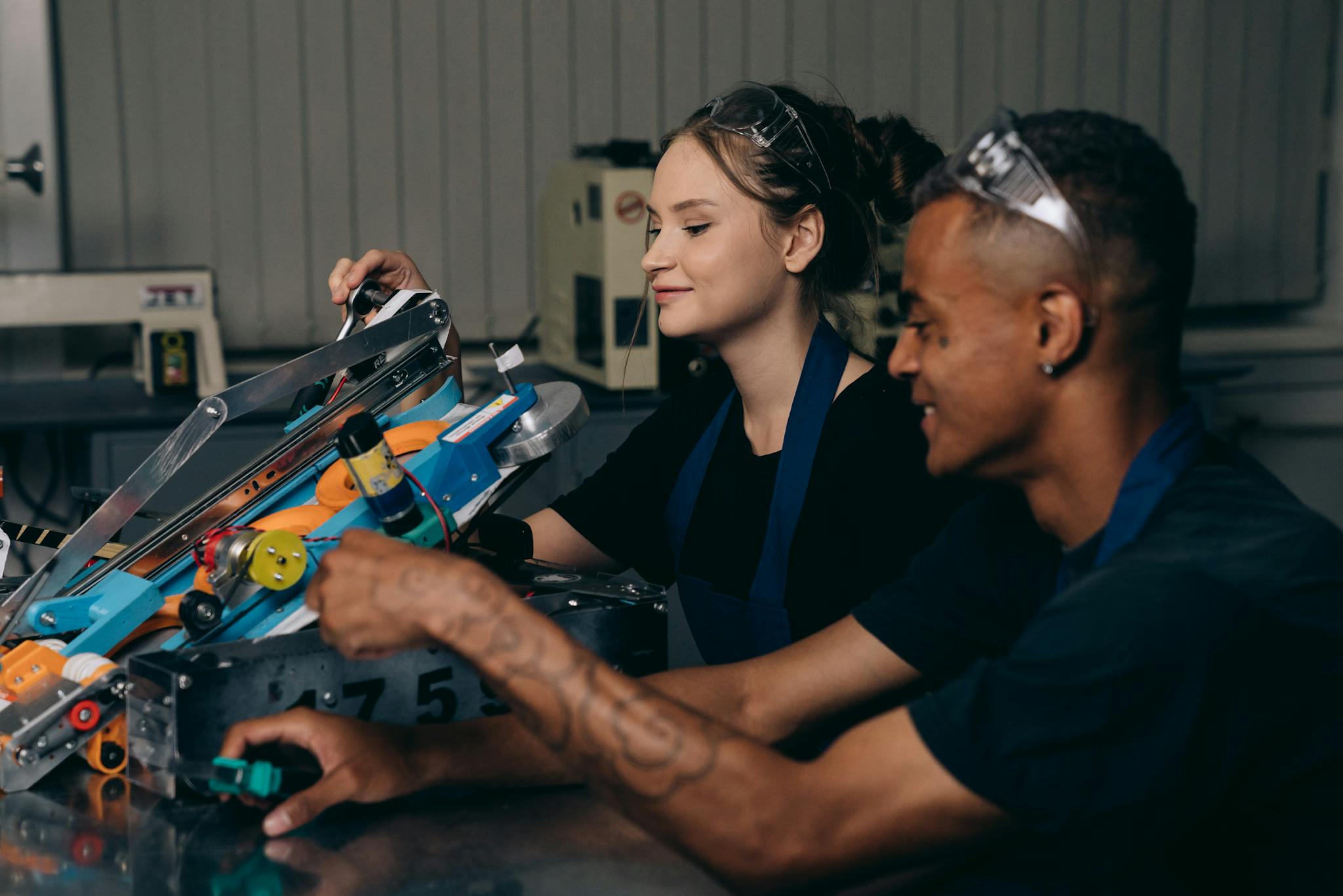 Two engineers working on a robotics project, showcasing teamwork and innovation.